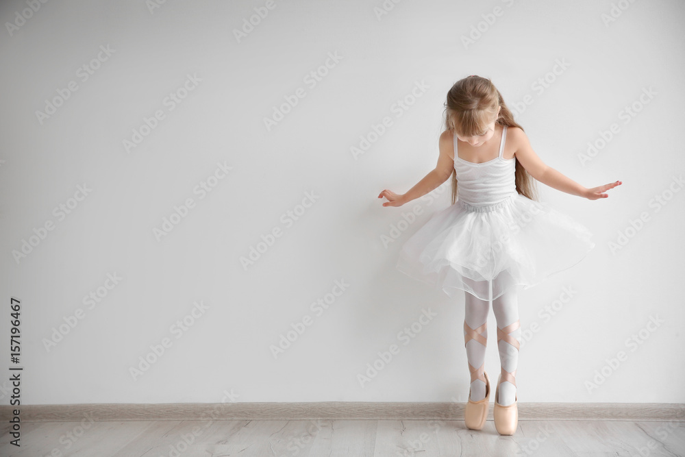 Beautiful little ballerina in light dance studio Beautiful little ballerina in light dance studio
