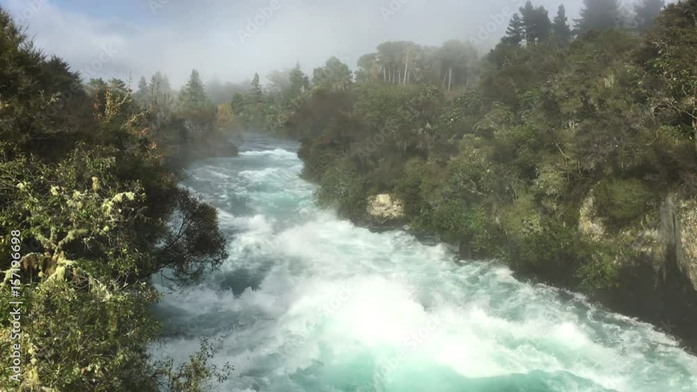 Wild rushing stream of Huka Falls near Lake Taupo in the North Island of New Zealand Wild rushing stream of Huka Falls near Lake Taupo in the North Island of New Zealand