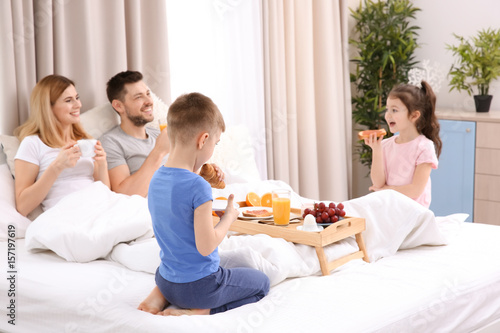Happy family having breakfa...