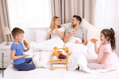 Happy family having breakfa...