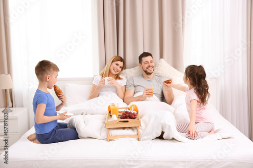 Happy family having breakfa...