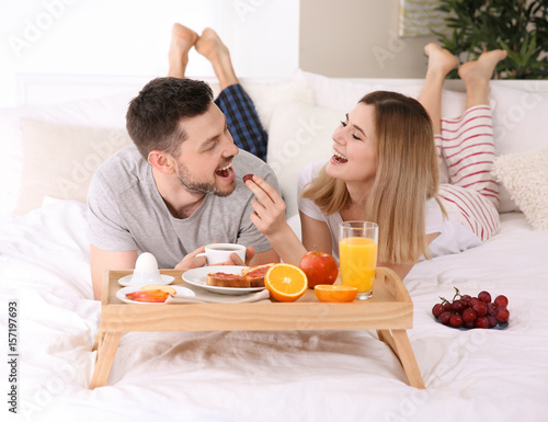 Happy couple having breakfa...