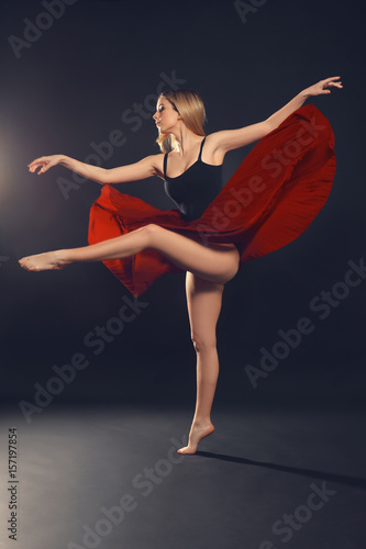 Beautiful young dancer on dark background