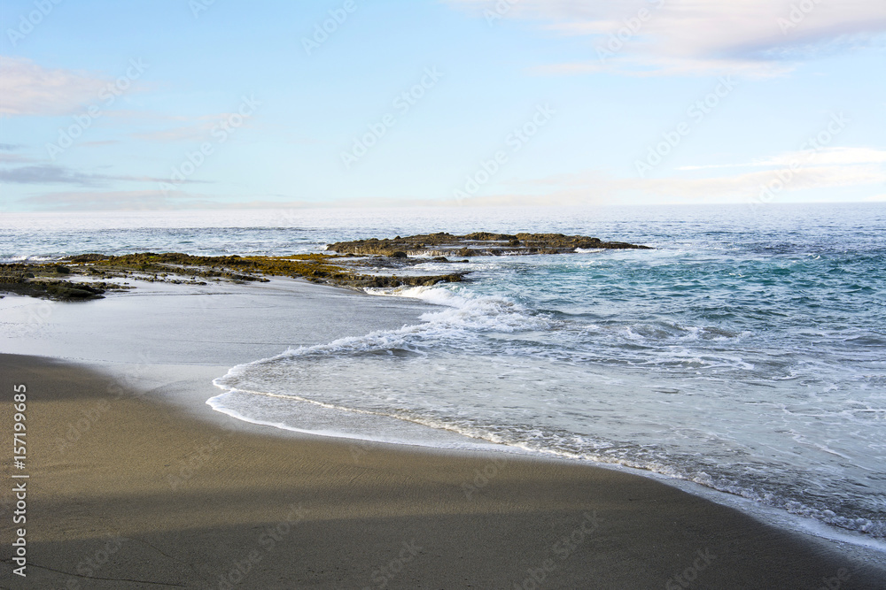 Beach shoreline with gentle surf