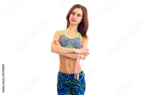 Sportive woman holding centimeter