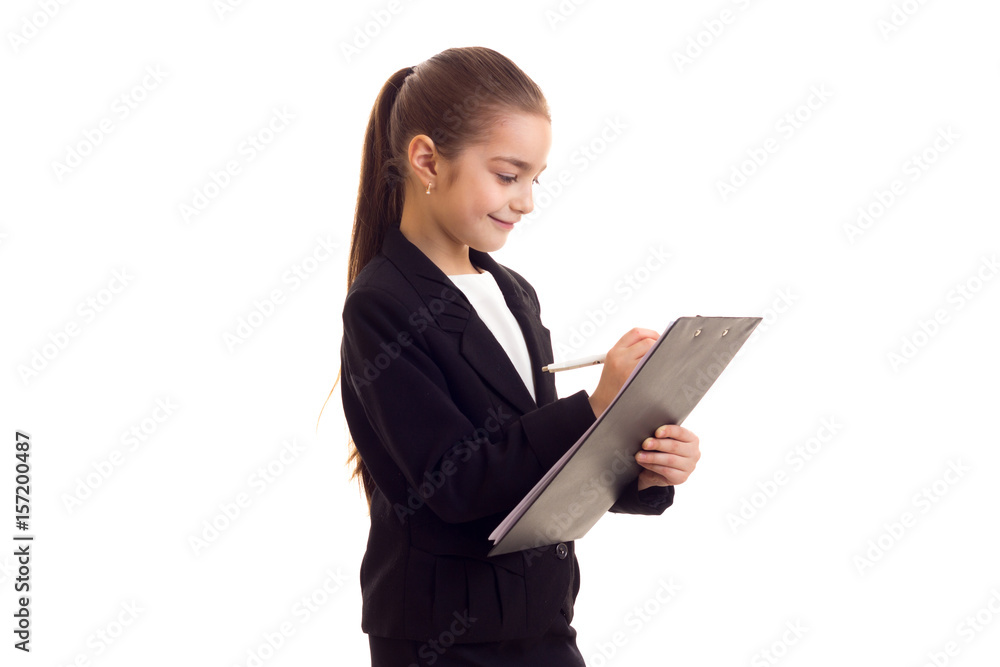 Little girl in black jacket holding pen and folder Little girl in black jacket holding pen and folder