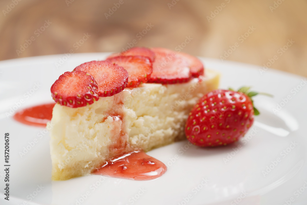cheesecake with strawberry on plate closeup, shallow focus cheesecake with strawberry on plate closeup, shallow focus