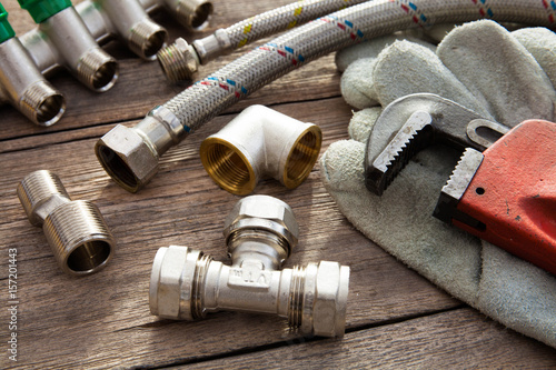 Set of plumbing and tools on the wooden table