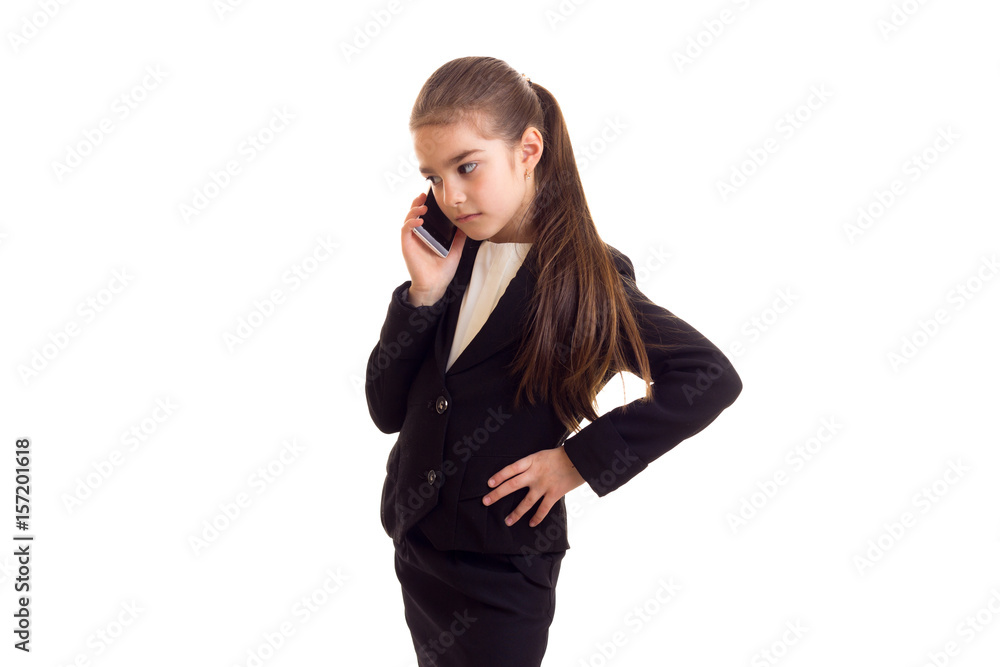 Little girl in black jacket talking on phone Little girl in black jacket talking on phone