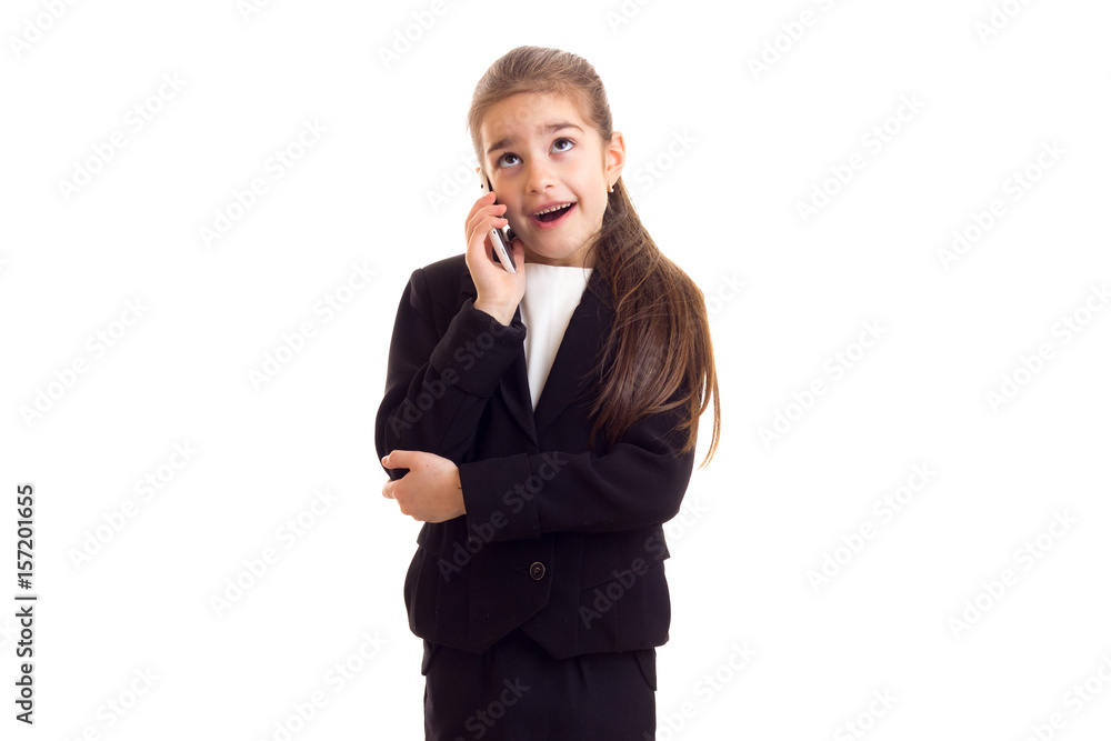 Little girl in black jacket talking on phone Little girl in black jacket talking on phone