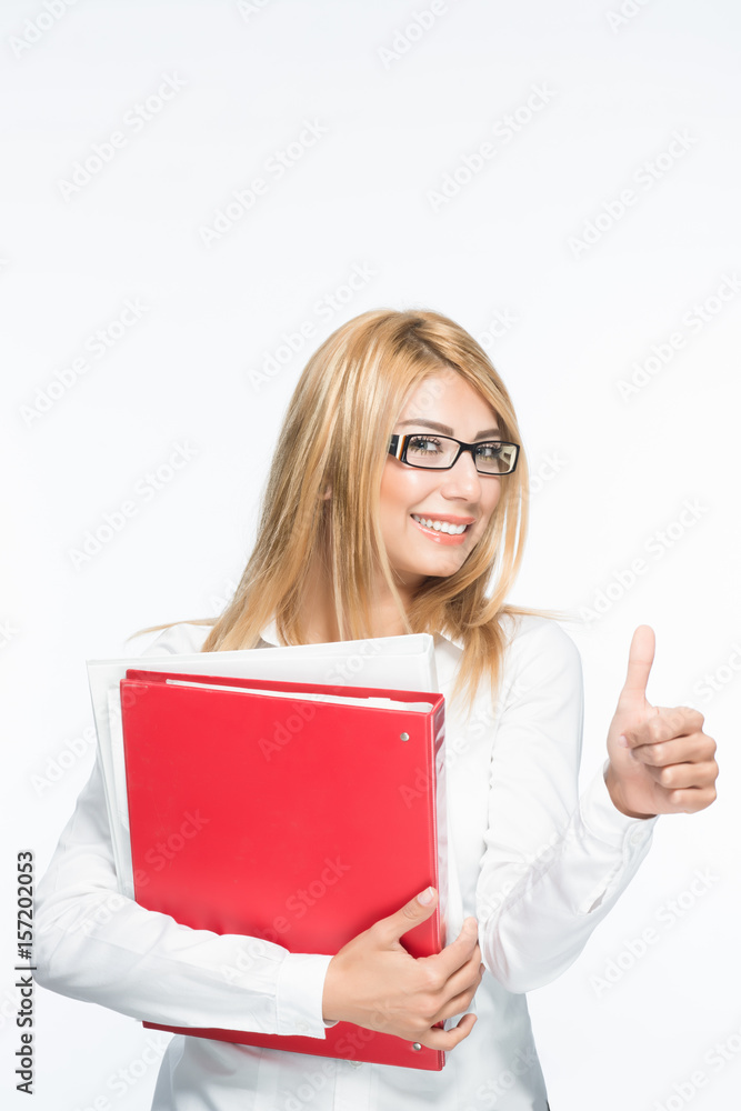 Blonde pretty lady holding red folders with thumbs up gesture and smiling Blonde pretty lady holding red folders with thumbs up gesture and smiling