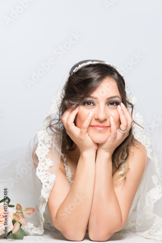 Happy and hopefull bride posing on the floor for engagement and marriage photo