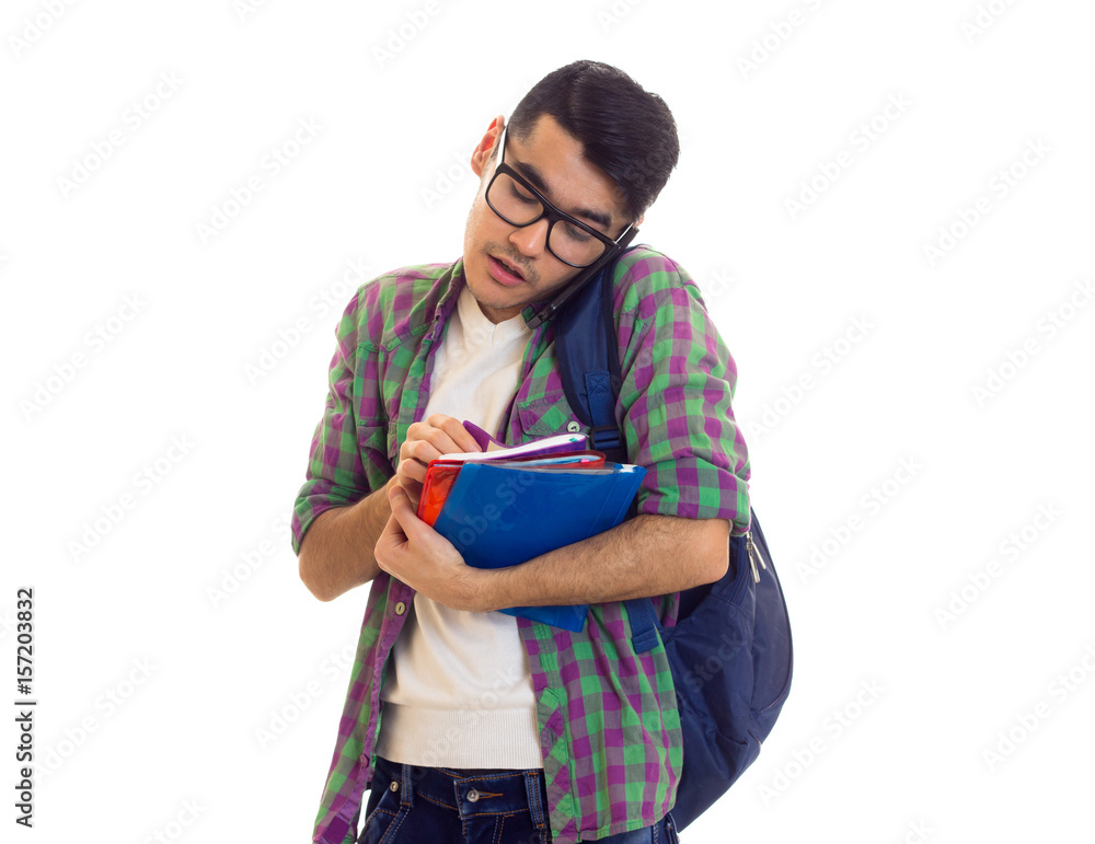 Young man with backpack, smartphone and books Young man with backpack, smartphone and books