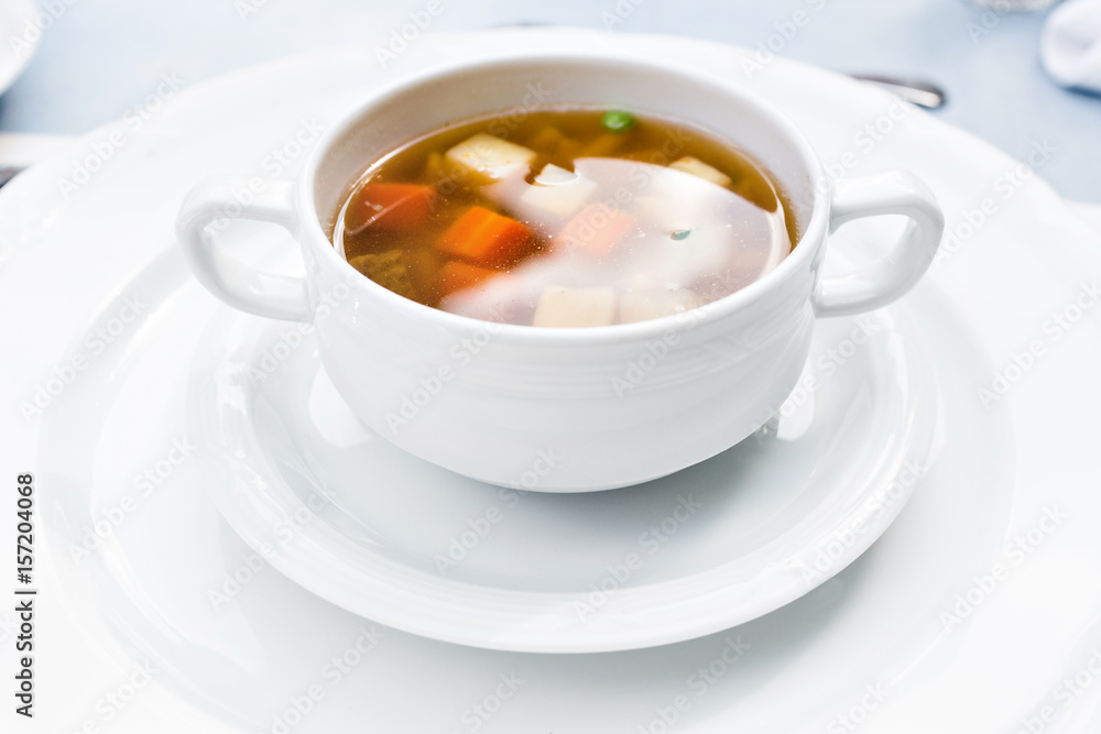 A bowl of delicious beef and barley soup with carrots, tomato, potato, celery, and peas. A bowl of delicious beef and barley soup with carrots, tomato, potato, celery, and peas.