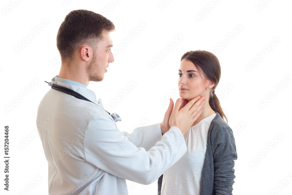 young doctor examines hands throat cute girl close-up