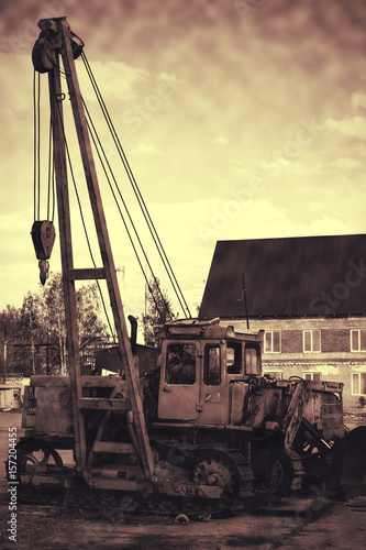 Old rusty tractor abandoned in a landfill. photo