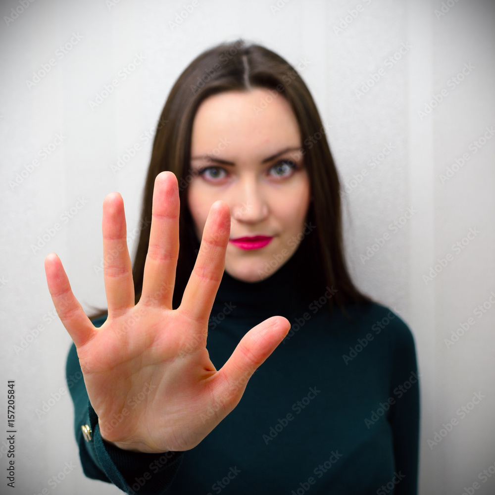 Girl holding hand like sign No. Negation, discrimination, violence concept. Girl holding hand like sign No. Negation, discrimination, violence concept.
