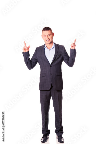 Young businessman pointing upwards