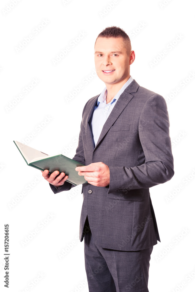Young businessman reading his note book Young businessman reading his note book