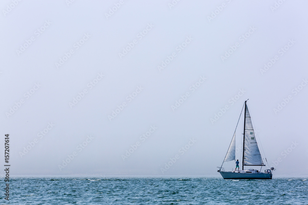 Fototapeta premium Sailing in misty lake