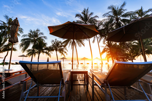 Tropical beach destination landscape with swimming pool and palm trees