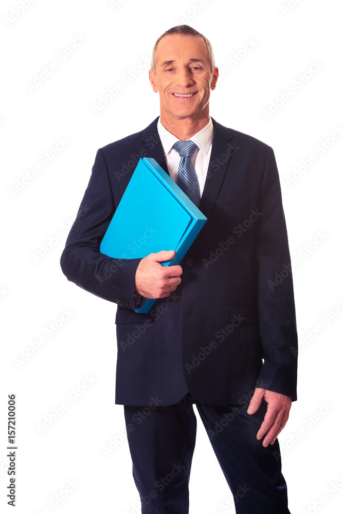 Mature businessman holding a binder Mature businessman holding a binder