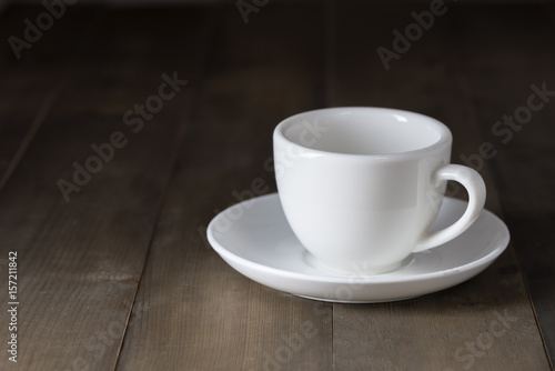white cup of coffee on brown wood table