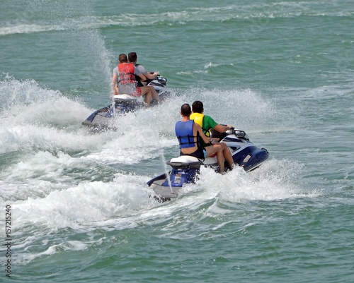 Jet ski riders running waves on the florida intra-coastal waterway off Miami Beach.