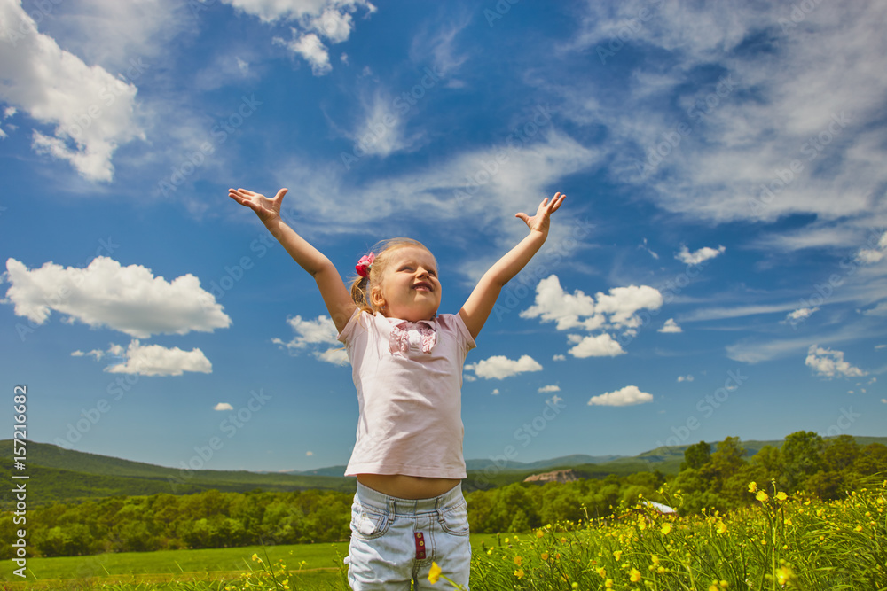 Small girl on tthe meadow in sunny day happy and enjoing beautiful weather Small girl on tthe meadow in sunny day happy and enjoing beautiful weather