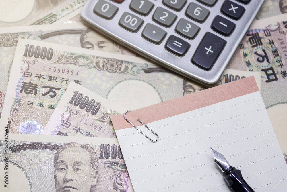fountain pen, empty paper and calculator with ten thousand yen banknote, for business and financial concept. fountain pen, empty paper and calculator with ten thousand yen banknote, for business and financial concept.