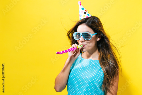 Young woman with party hat with noisemaker
