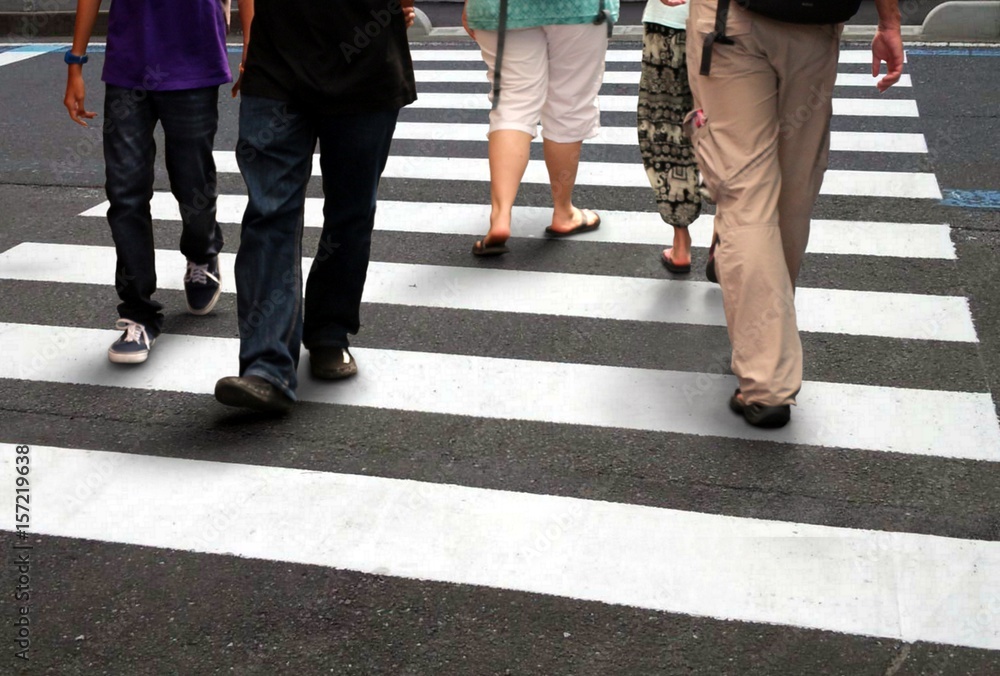 People crossing road during rush hour