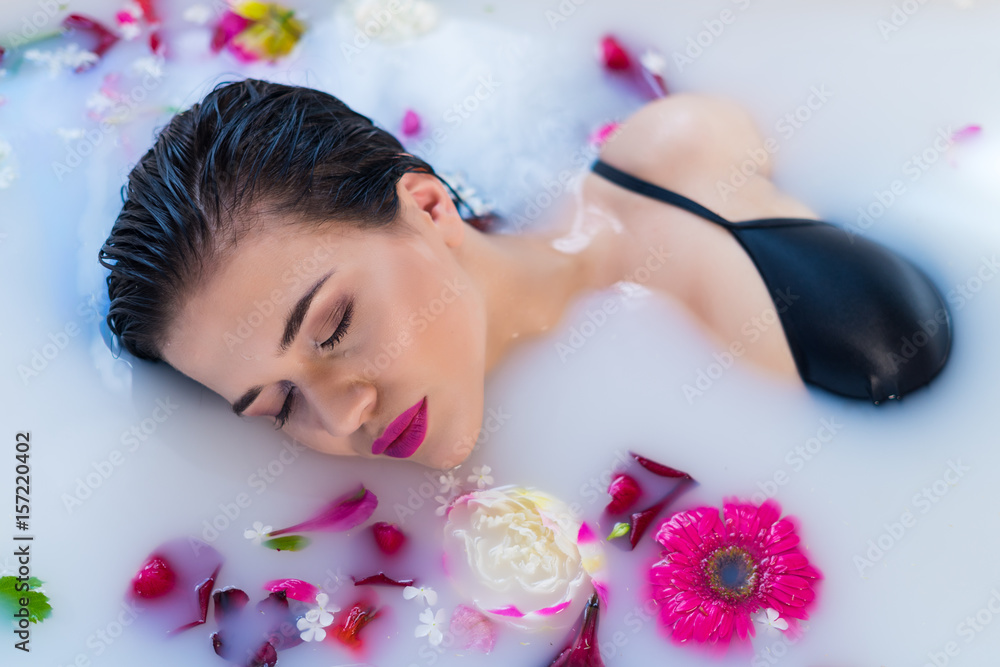 Closeup view of Woman in bath. Sexy brunette woman relaxing in hot milk  bathtube with flowers. she is wearing black sexual lingerie. Spa  satisfaction Photos | Adobe Stock