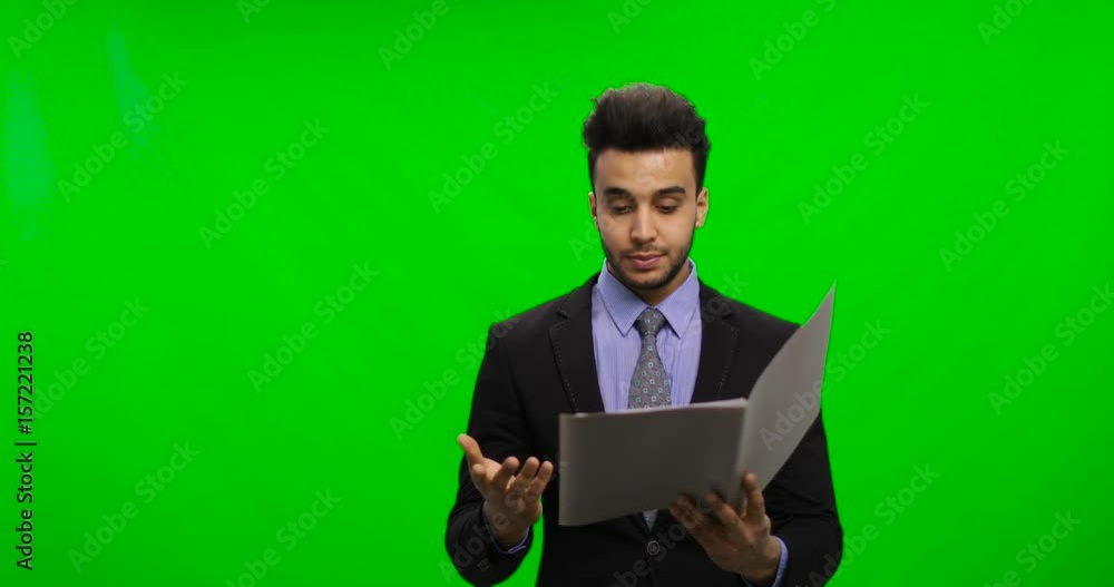 Serious Businessman Read Documents Over Chroma Key Green Screen Hold Reports Pensive Having Problem Portrait of Young Latin Business Man Serious Businessman Read Documents Over Chroma Key Green Screen Hold Reports Pensive Having Problem Portrait of Young Latin Business Man