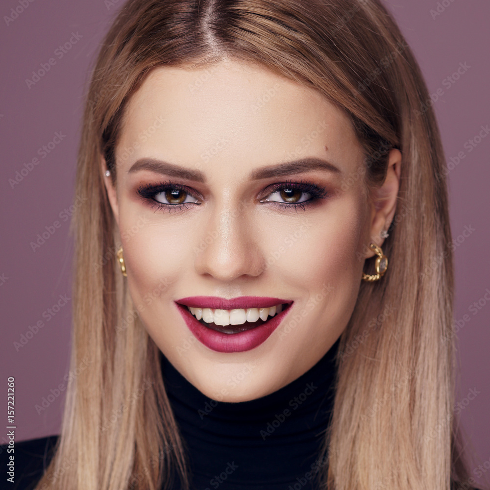 Face portrait of young beautiful happy smiling girl woth long blonde hair and perfect makeup with dark cherry lips Face portrait of young beautiful happy smiling girl woth long blonde hair and perfect makeup with dark cherry lips