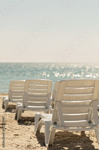 Lots of sun loungers on the beach near the sea. © COLOR PHOTO