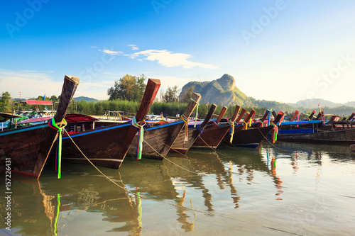 Colorful long tail boats on a tropical island at Krabi Thailand photo