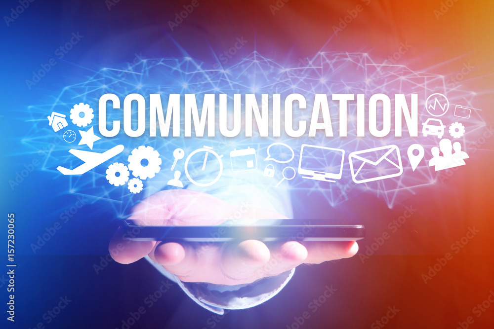 Concept of man holding a futuristic interface with communication title and multimedia icons flying all around - Internet concept Concept of man holding a futuristic interface with communication title and multimedia icons flying all around - Internet concept