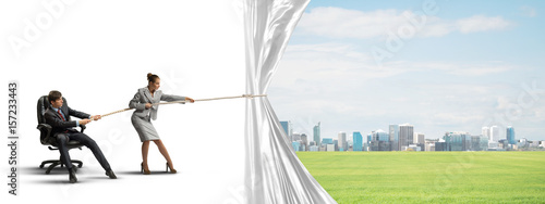 Foto Young businesspeople working in collaboration and pulling white advertisement ba