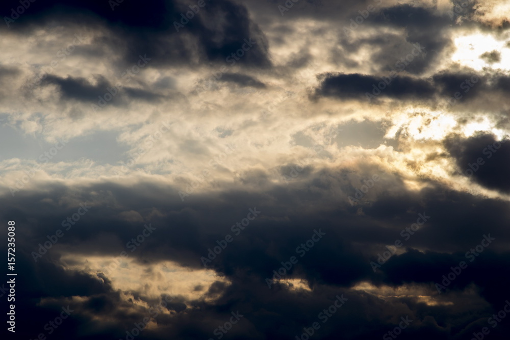 Cumulus clouds with sun rays, dramatic sky