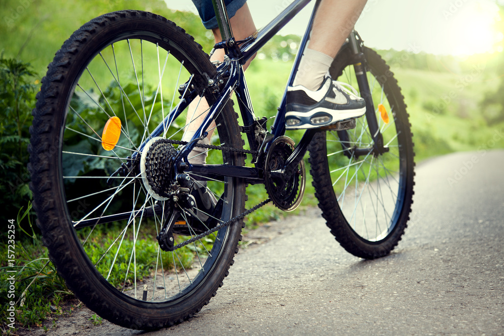 teenager riding a bicycle on the road summer sunlit teenager riding a bicycle on the road summer sunlit