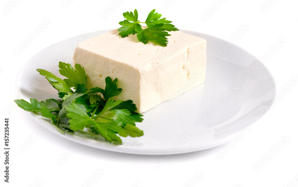 Part of Bryndza on the white plate with greens. Isolated Part of Bryndza on the white plate with greens. Isolated