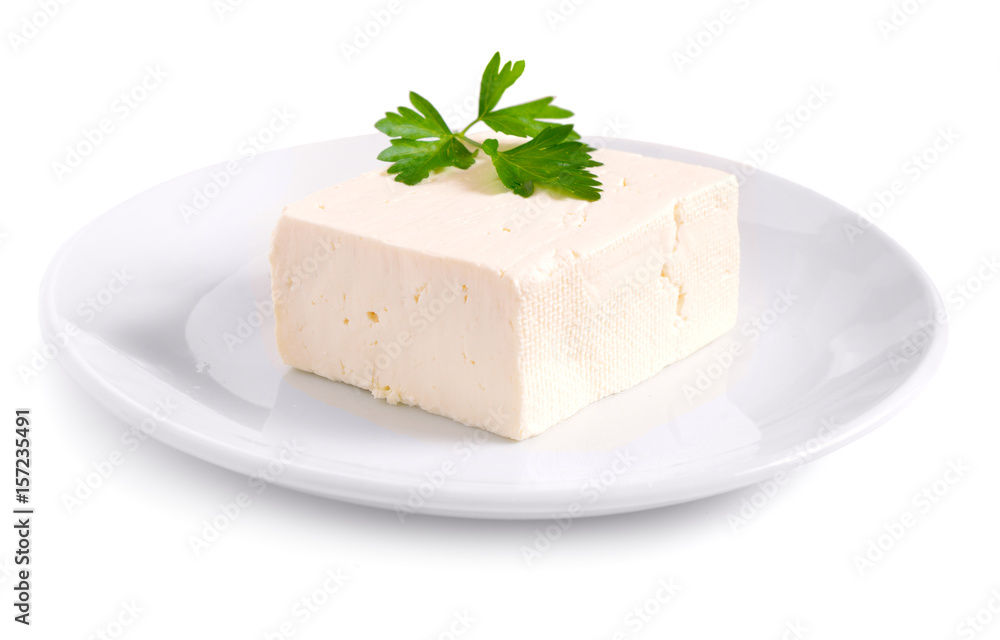 Part of Bryndza on the white plate with greens. Isolated Part of Bryndza on the white plate with greens. Isolated