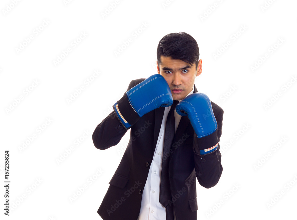 Young man in suit with boxing gloves Young man in suit with boxing gloves