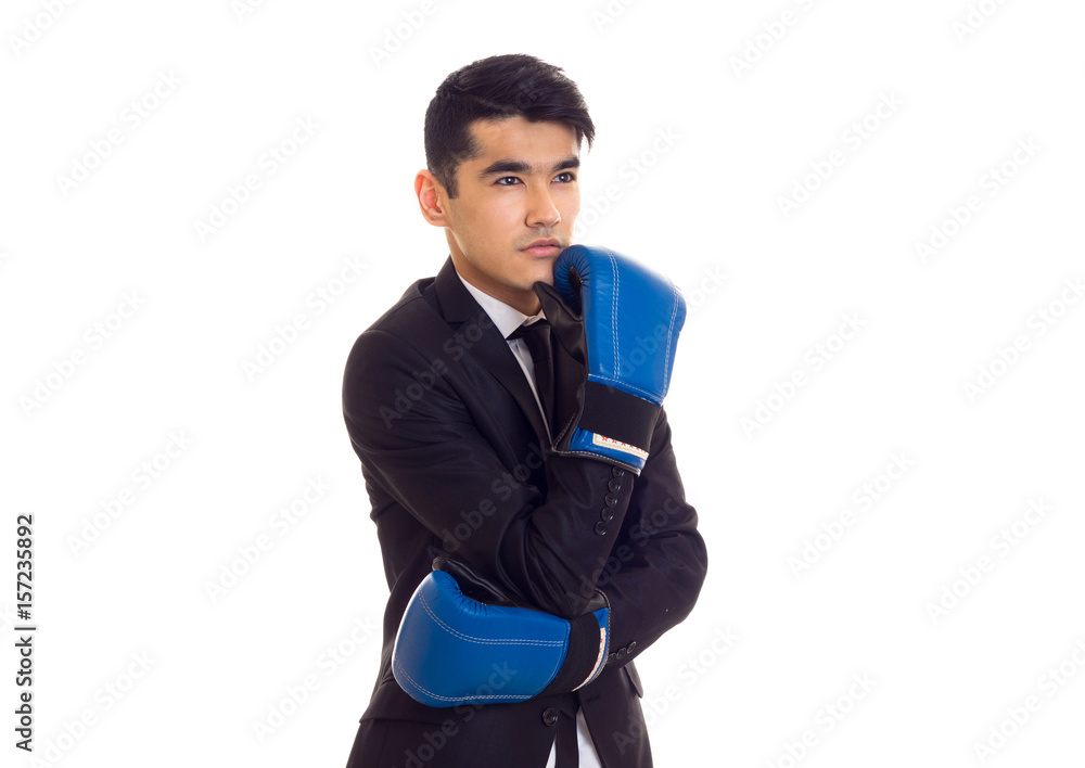 Young man in suit with boxing gloves Young man in suit with boxing gloves