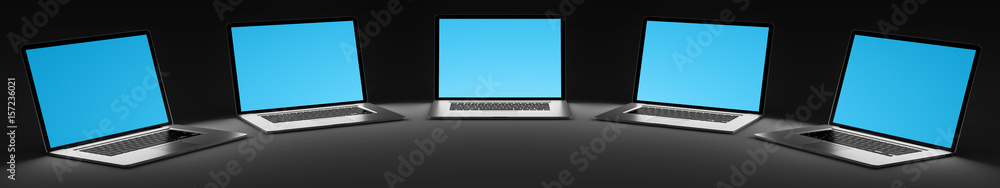 Five modern laptop in the dark 3D rendering Five modern laptop in the dark 3D rendering