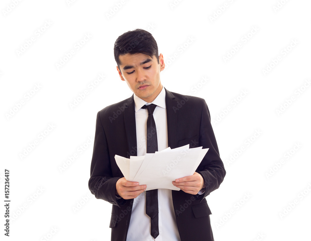 Young man in suit holding papers Young man in suit holding papers