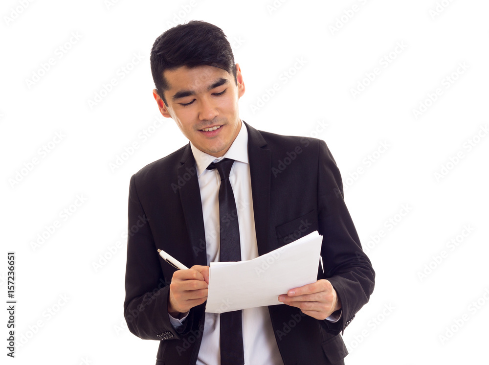 Young man in suit holding papers Young man in suit holding papers