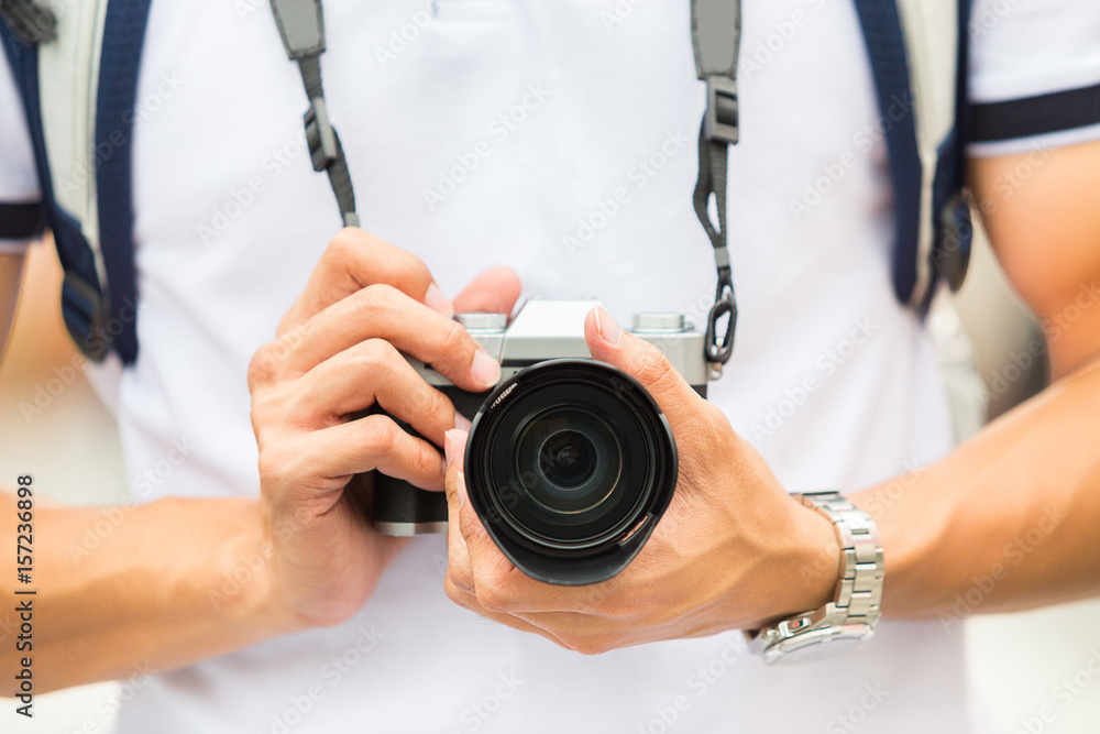 digital camera in hand of travel man digital camera in hand of travel man