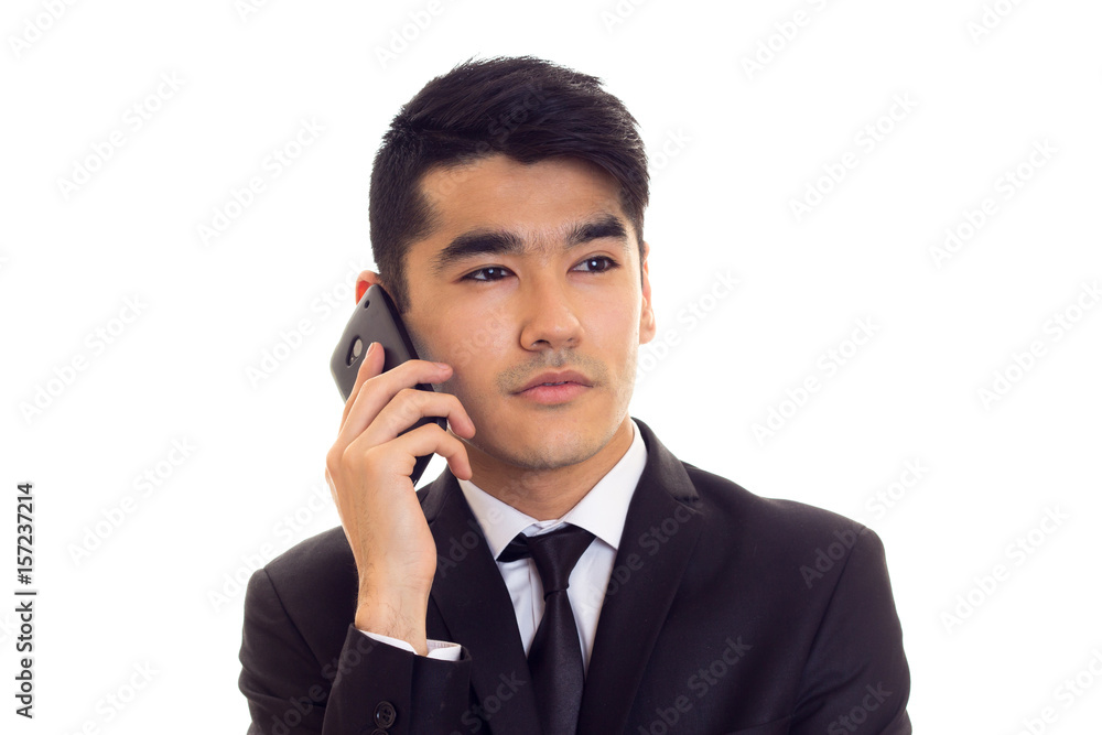 Young man in suit talking on the phone Young man in suit talking on the phone